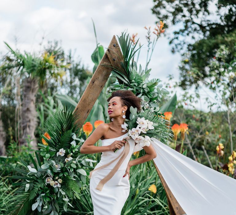 Bride in white Maddox wedding dress holding jungle themed bouquet at Urban Jungle Suffolk