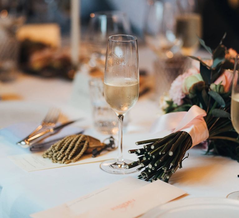 Wedding day champagne with pink ribbon flower bouquet 