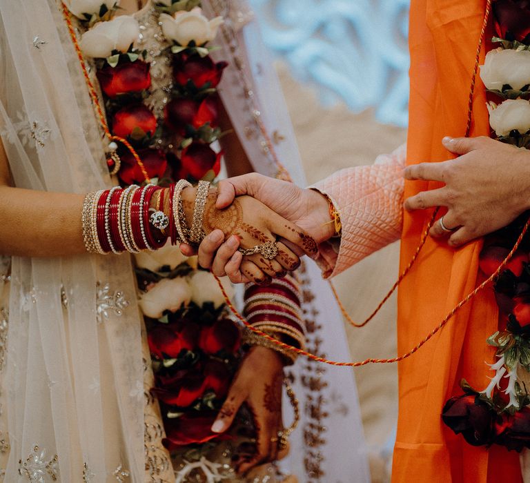 Groom holds brides hand during ceremony 