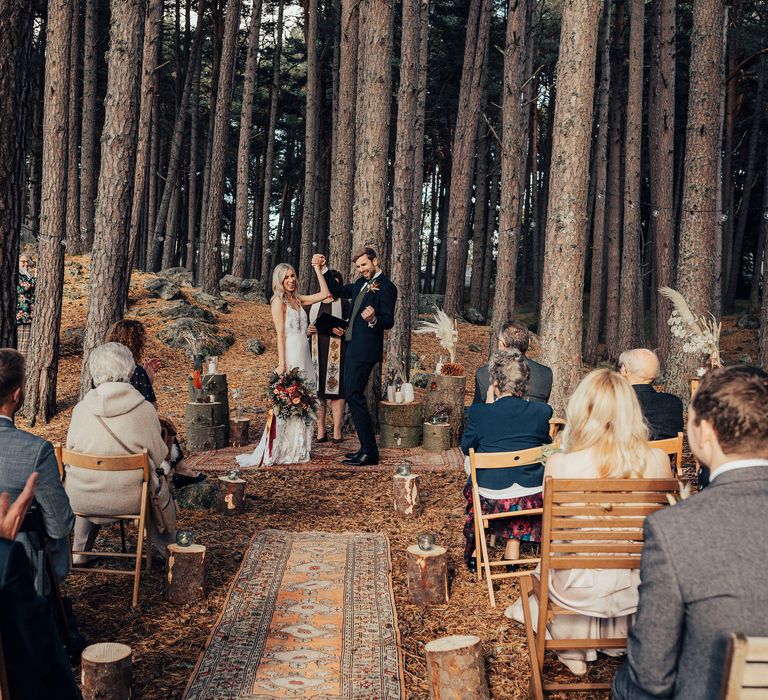 Bride & groom in woodland ceremony celebrate after marriage