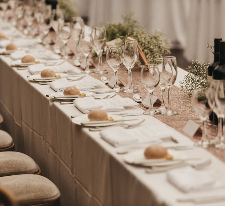 Top table with rose gold glitter table runner and gypsophila flowers 