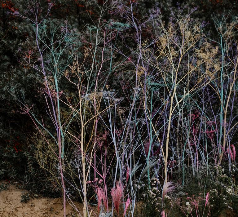 spray painted Scabiosa stems in the sand at beach elopement 