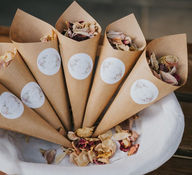 Brown paper cones with white stickers filled with confetti 