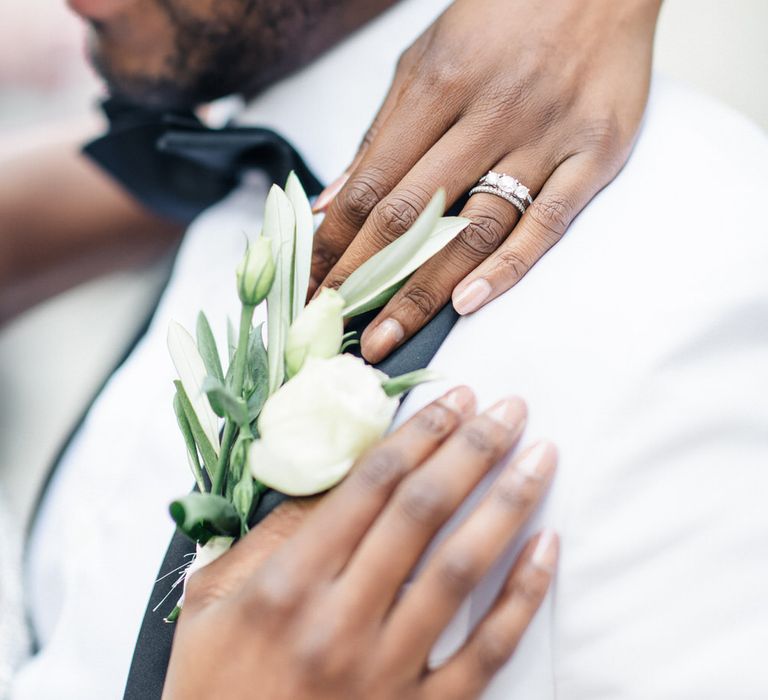 Groom wears white floral buttonhole and Monochrome tux