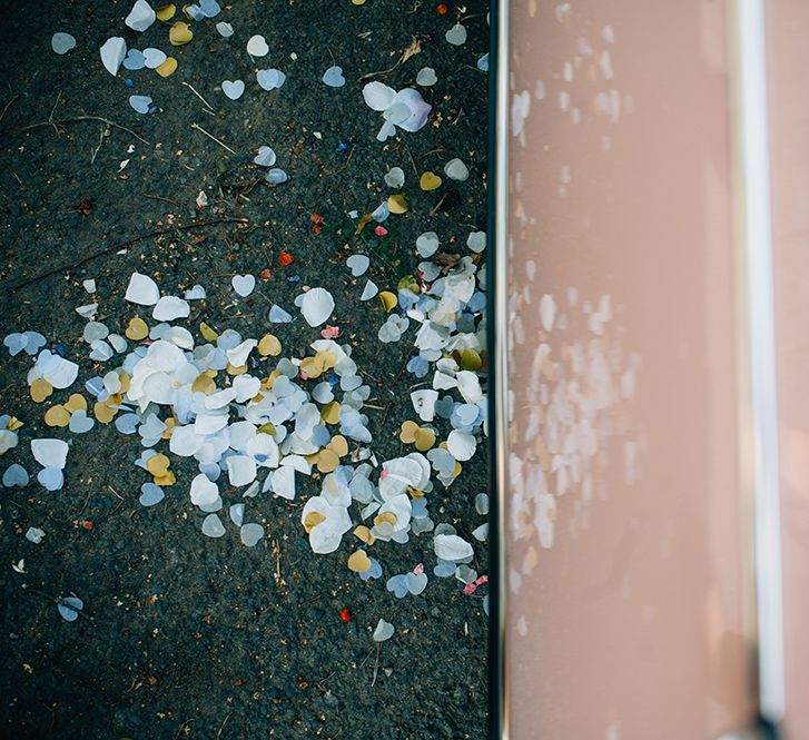 White blue and yellow confetti scattered in the floor