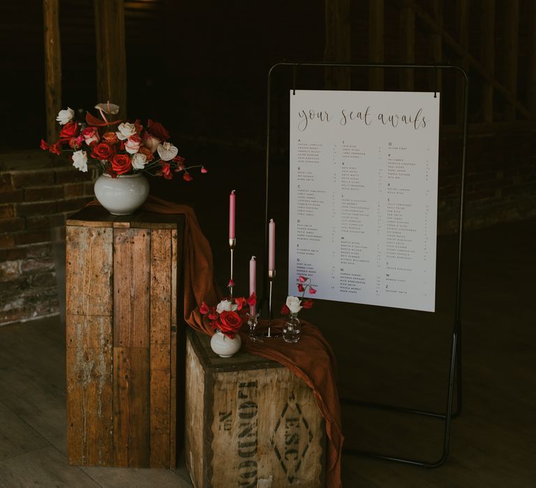 Rustic decor with table plan and florals upon wooden boxes