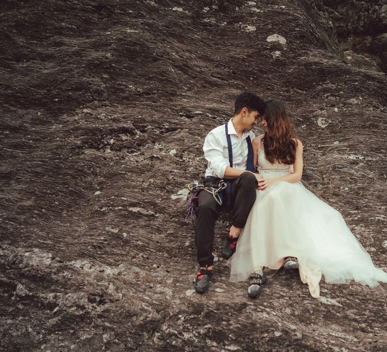 Couple sit together on the mountains in Scotland