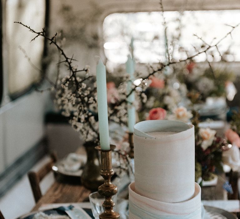 Rustic floral displays next to modern and contemporary wedding cake