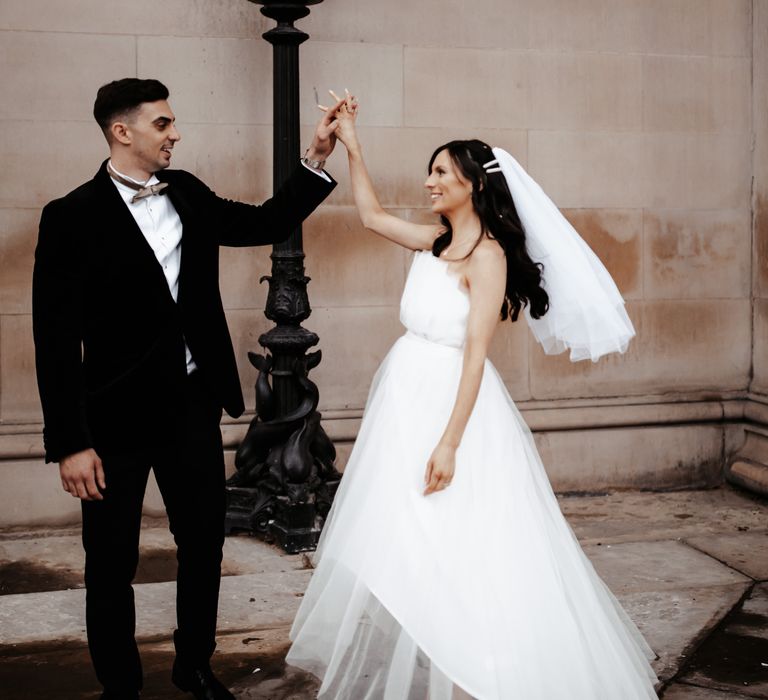 Bride & groom dance after wedding ceremony outdoors for couples portraits