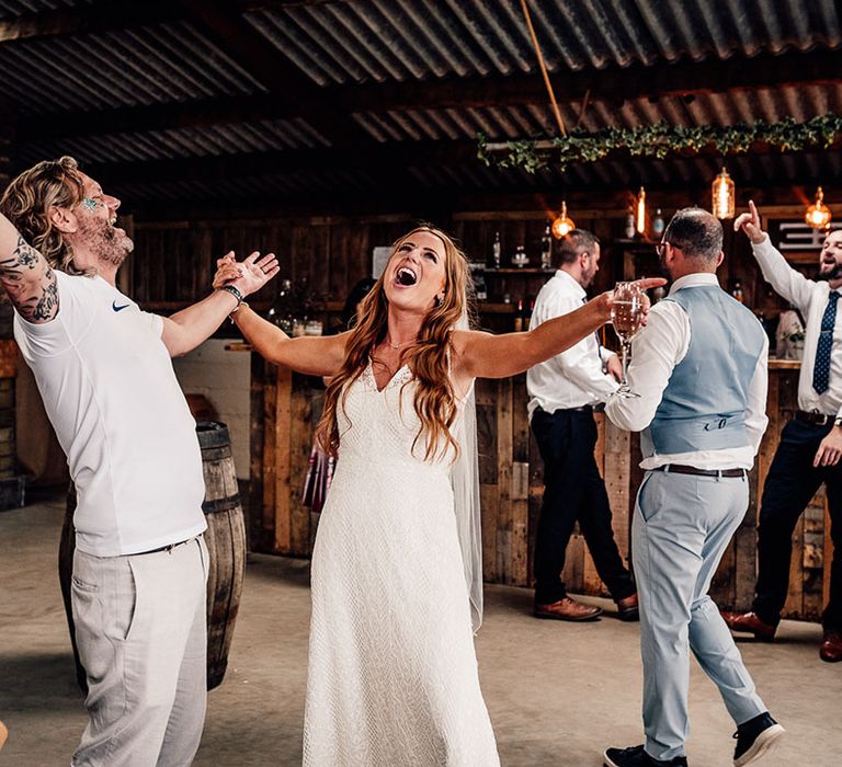 Bride and groom sing with their family and friends