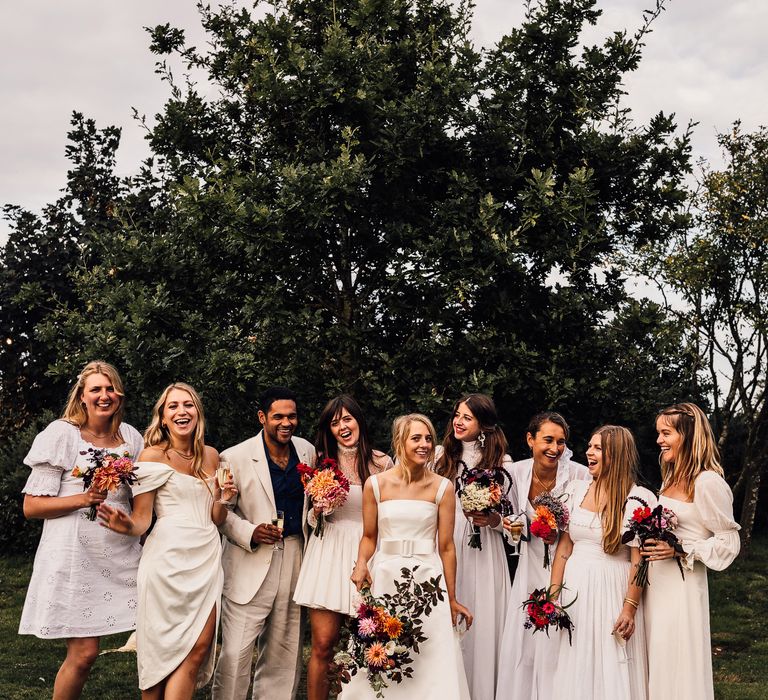 White bridesmaid dresses and suit for the bridal party