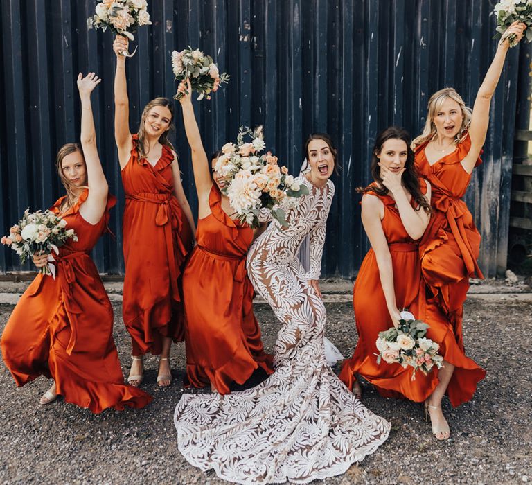 Bride in Rue De Seine (wedding dress) with bride party in orange bridesmaid dresses at Elmley Nature Reserve