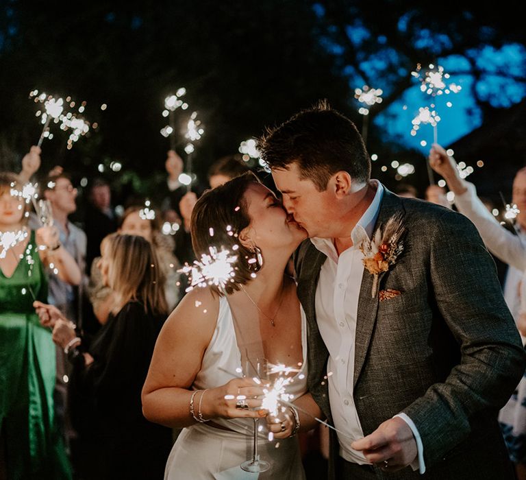 Sparkler moment with bride and groom kissing 