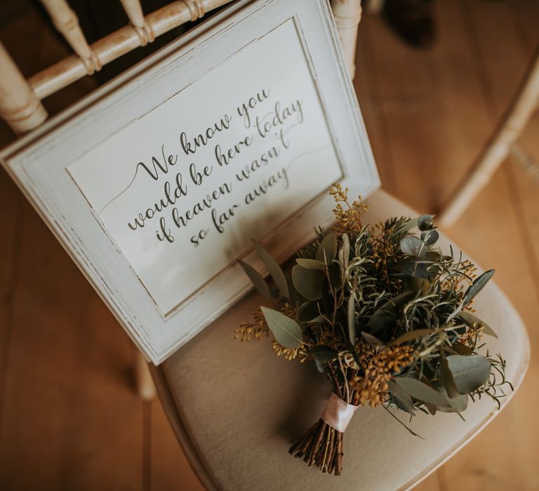 Dried floral and foliage bouquet with framed remembrance wedding sign for rustic barn wedding