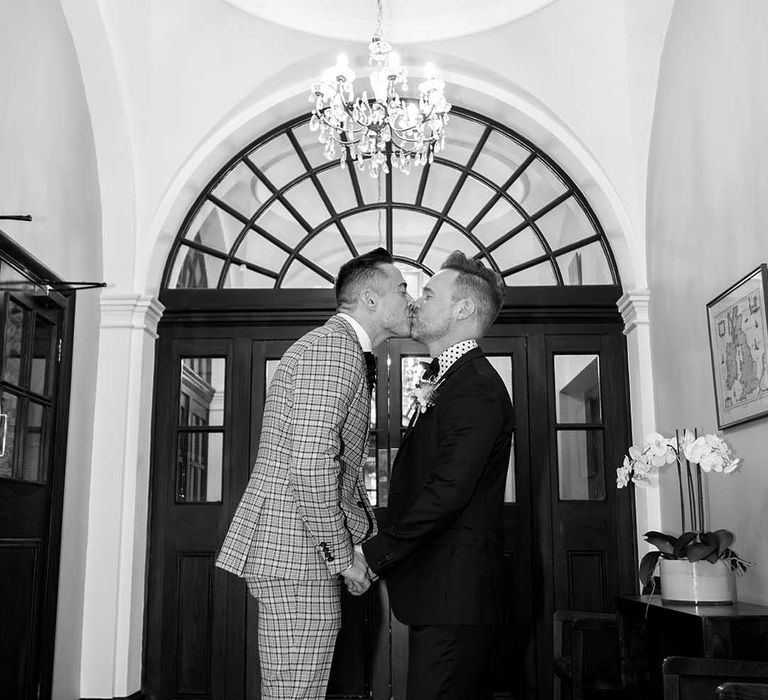 Grooms kiss at Chelsea Old Town Hall on their wedding day