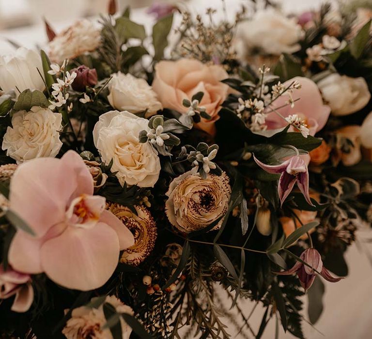 Mixed white, pink and yellow floral bouquet at multicultural wedding