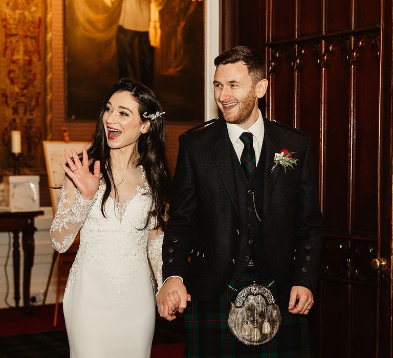 Bride & groom walk into wedding reception at Drumtochy Castle on their wedding day