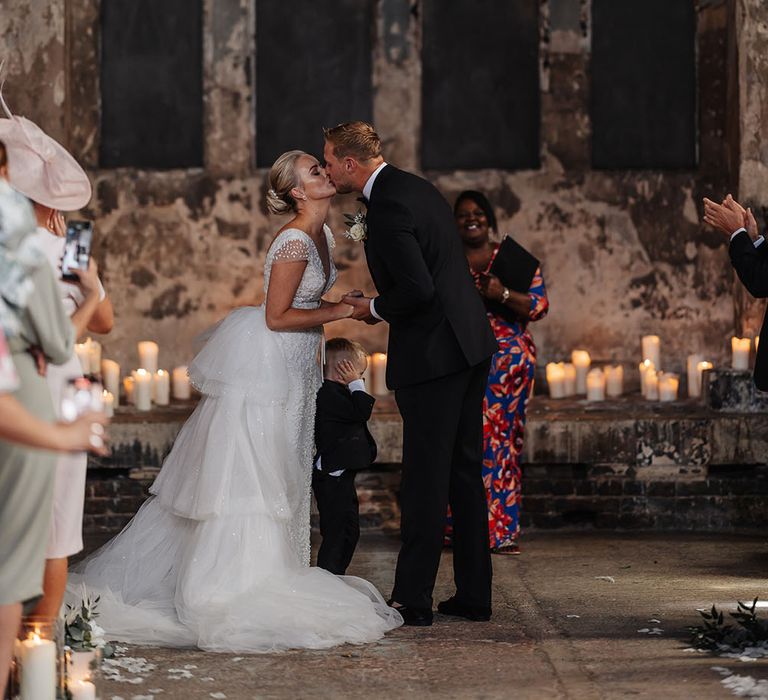 Bride & groom kiss during wedding ceremony at The Asylum for city wedding in London