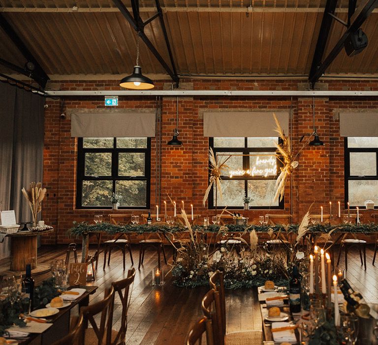 Rustic and boho styled reception with neon wedding sign and floral table runners 