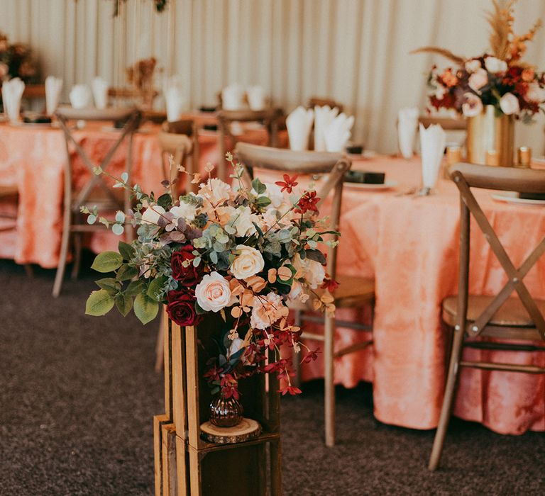 Floral installations line white carpet for boho chic styled wedding day