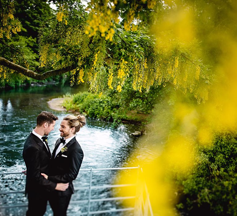 Groom wear black-tie and stand outdoors for couples portraits 