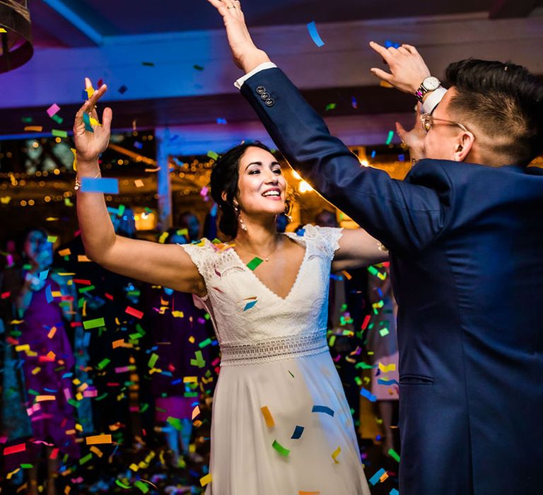 Bride dances with her groom during colourful confetti cannon 