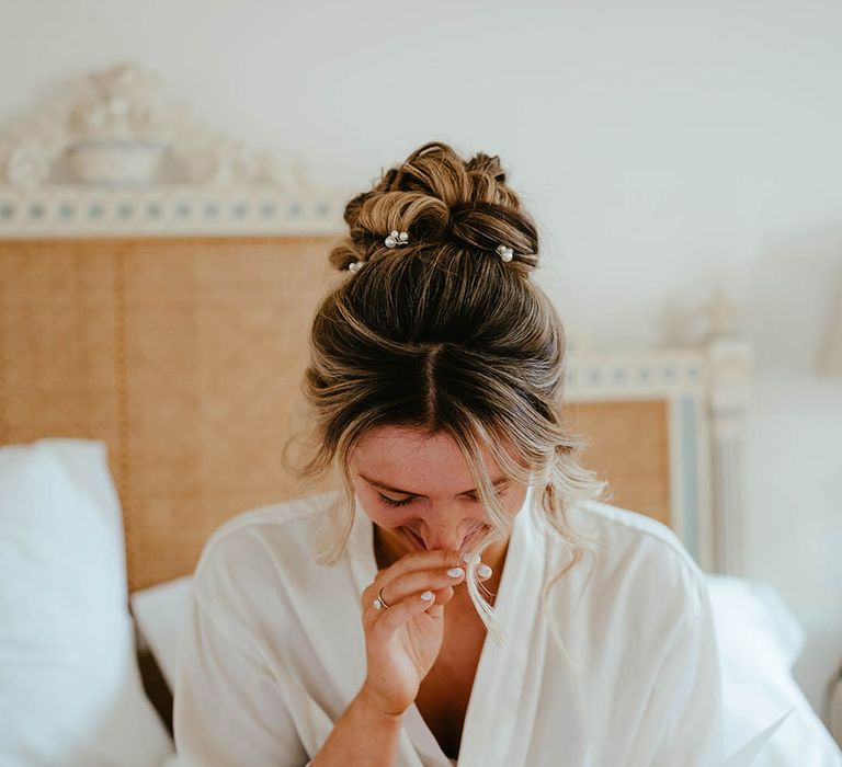 Bride with her hair styled in an updo with pearl hair pins 