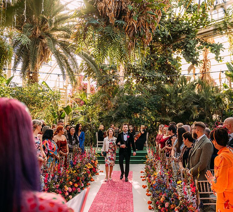 Sefton Park Palm House glasshouse wedding venue in Liverpool with bright aisle flowers 