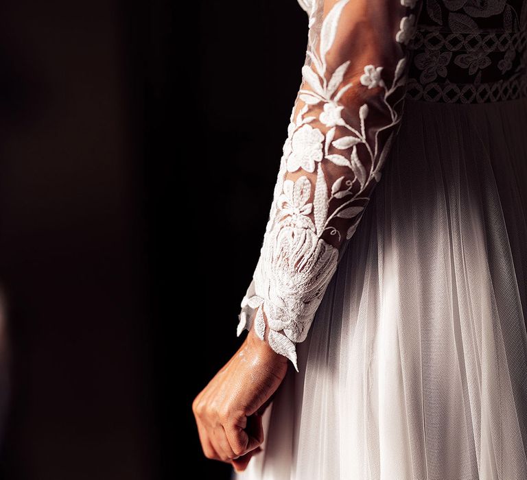 Close up of the bride's long sleeve lace wedding dress 