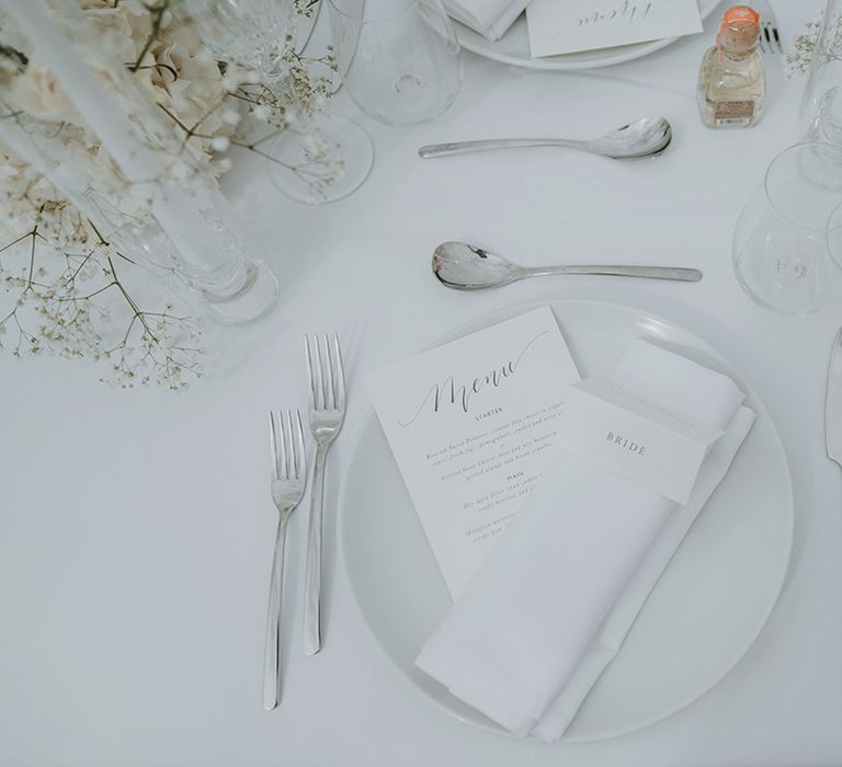 elegant wedding table place setting with menu card napkin and name place card