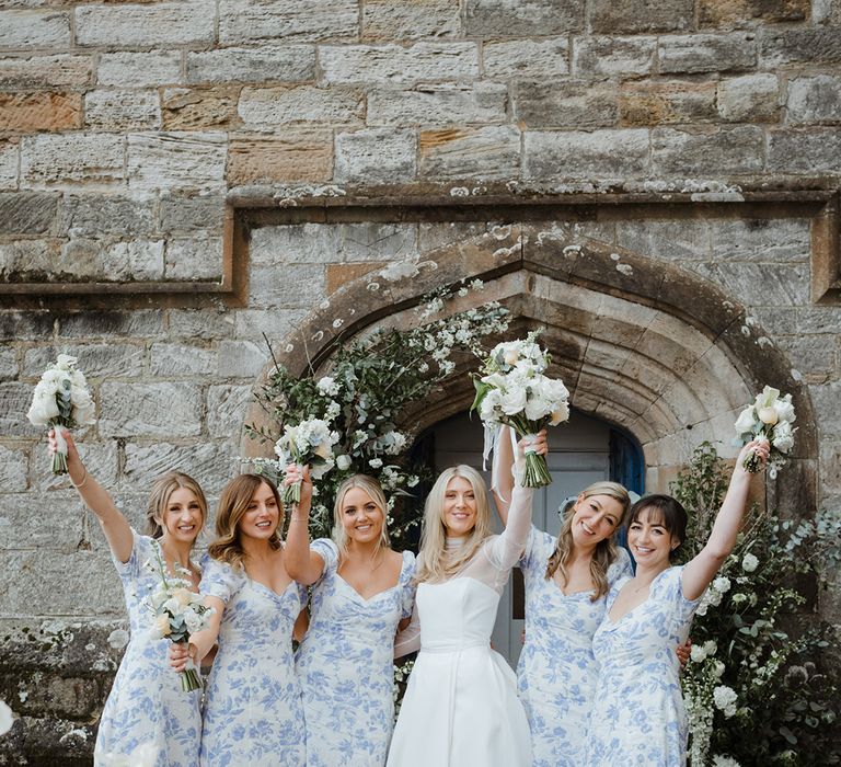 Bridesmaids in blue floral patterned bridesmaid dresses with bride in Jessica Bennett dress 