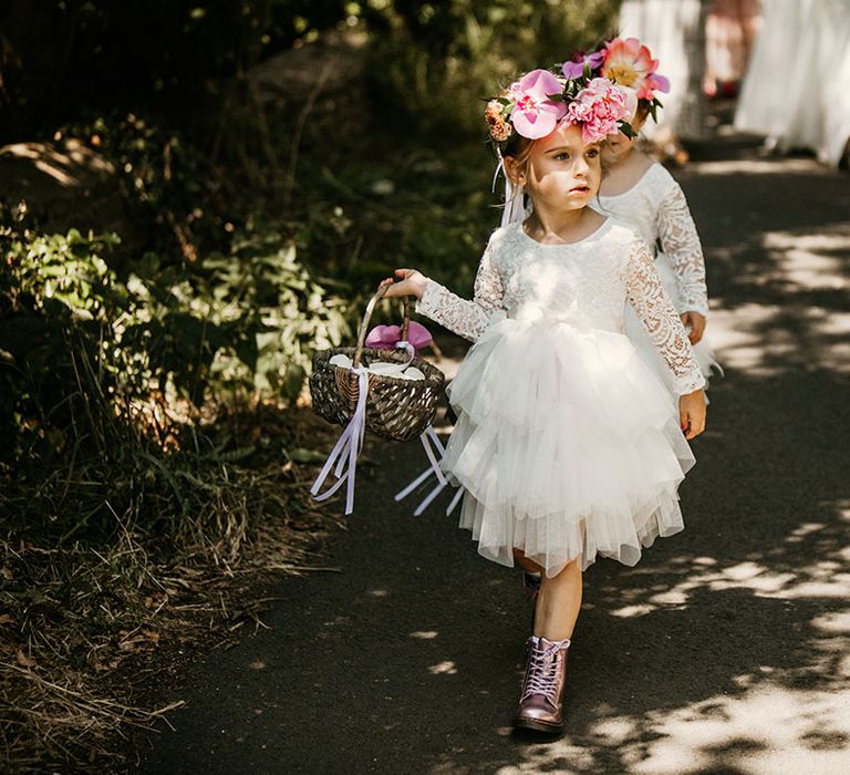 Flower girls in tulle white dresses with colourful flower crown in metallic purple boots 