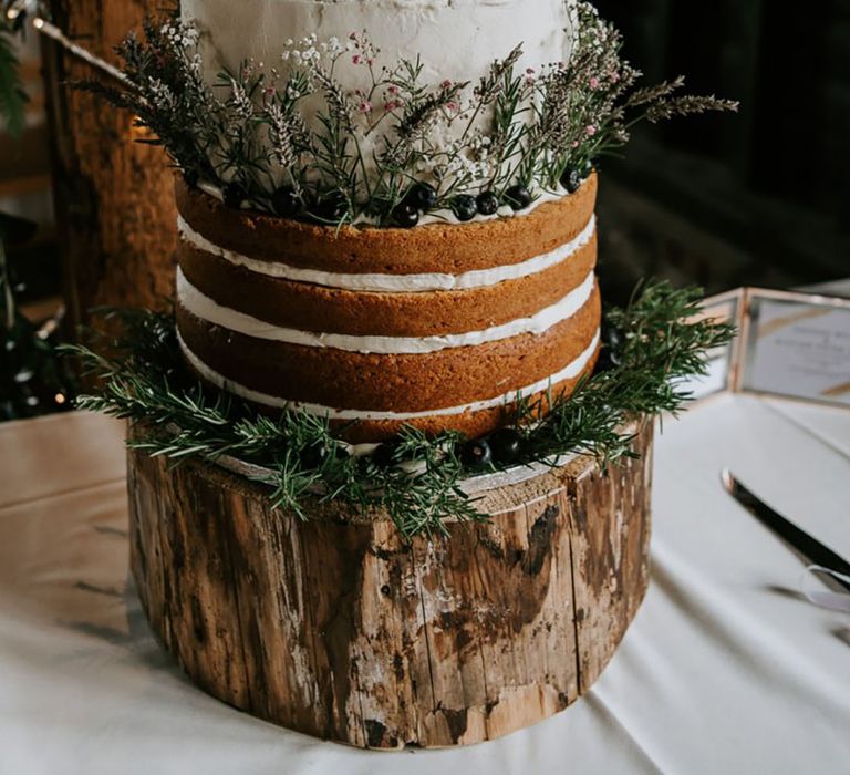 A sustainable wedding with a natural autumn wedding cake with natural greenery and foliage decor 