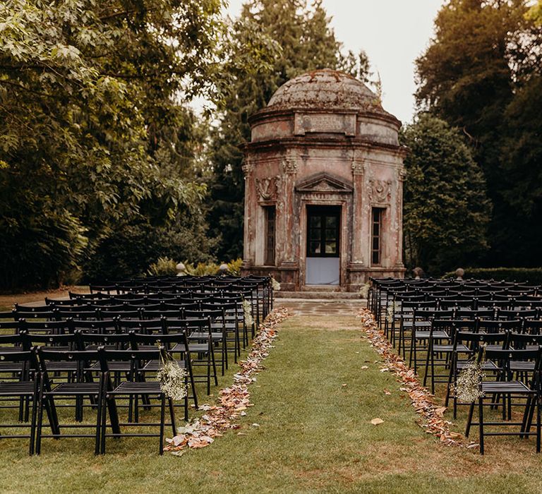 Larmer Tree Gardens wedding venue with autumnal leaves lining the aisle 