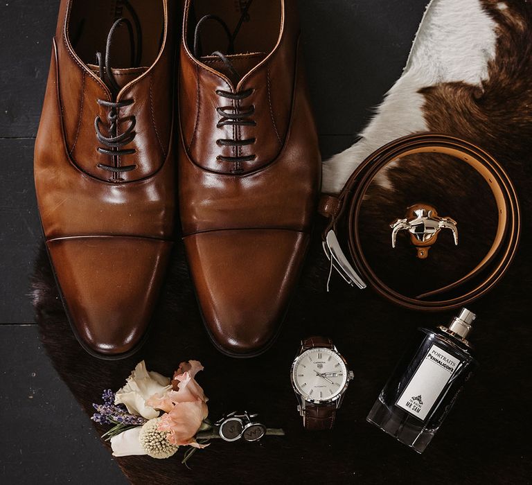 Groom accessories with brown shoes, cologne, belt and watch 