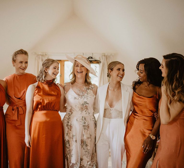 Bride with mother of the bride and bridesmaids in burnt orange bridesmaid dresses 