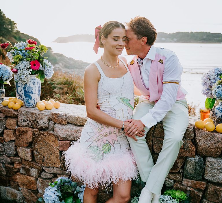 Maximalist wedding theme with bride in sequin feather wedding reception dress with groom at Italian theme wedding 