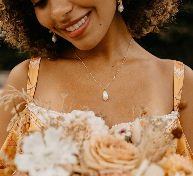 Bride wearing dainty pearl wedding jewellery 