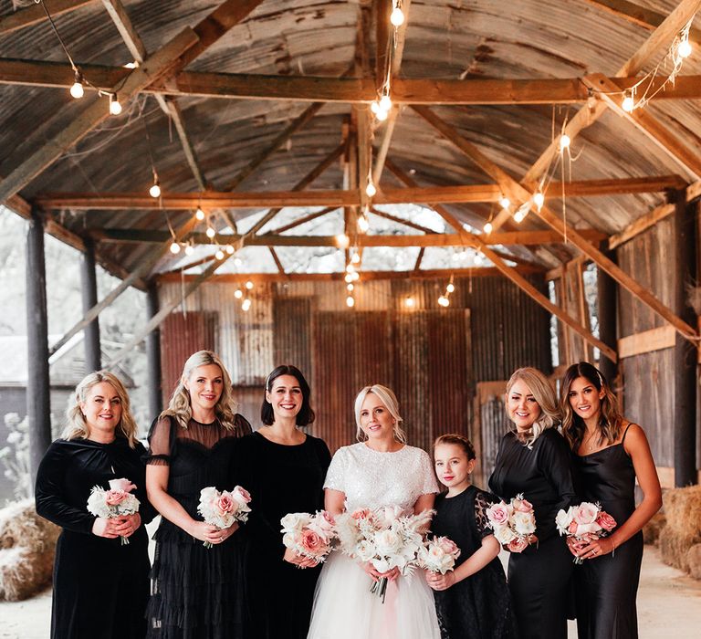 Bridal party in wintery black bridesmaid dresses for snowy wedding 