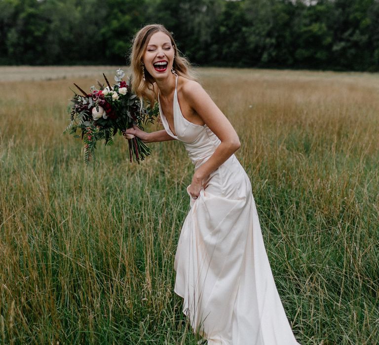 Beautiful bride in halterneck wedding dress and red lipstick