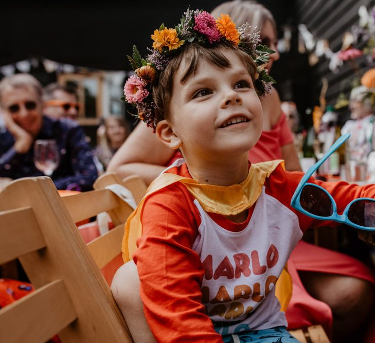 page boy in slogan t-shirt and flower crown 