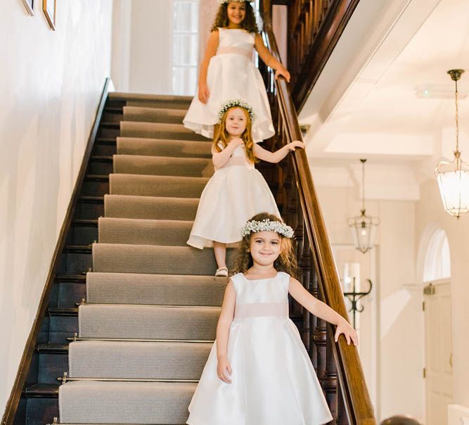 Flower girls in ivory dresses with gypsophila flower crowns