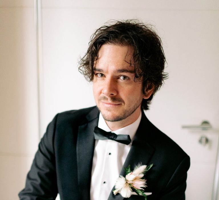 Groom on his wedding day with black tie wedding theme