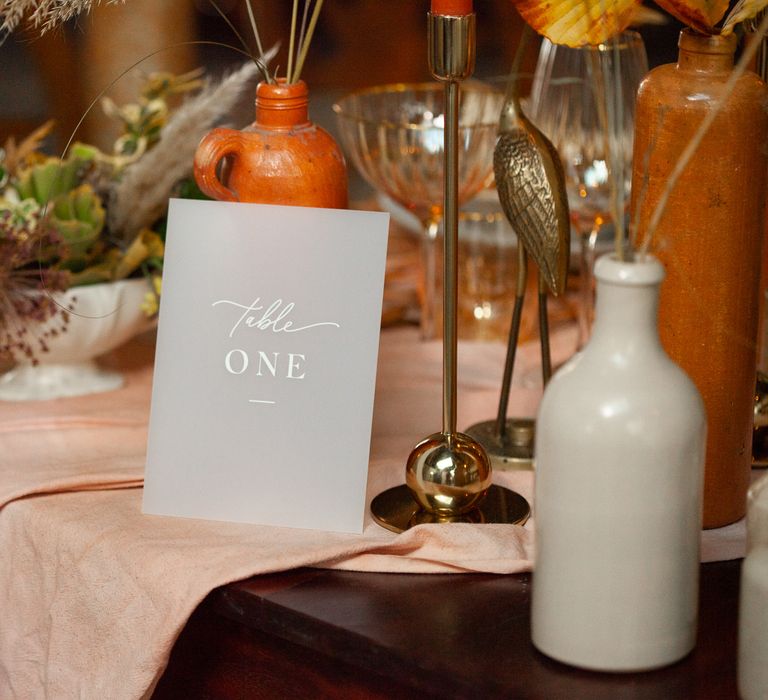 Light grey table number card with calligraphy writing