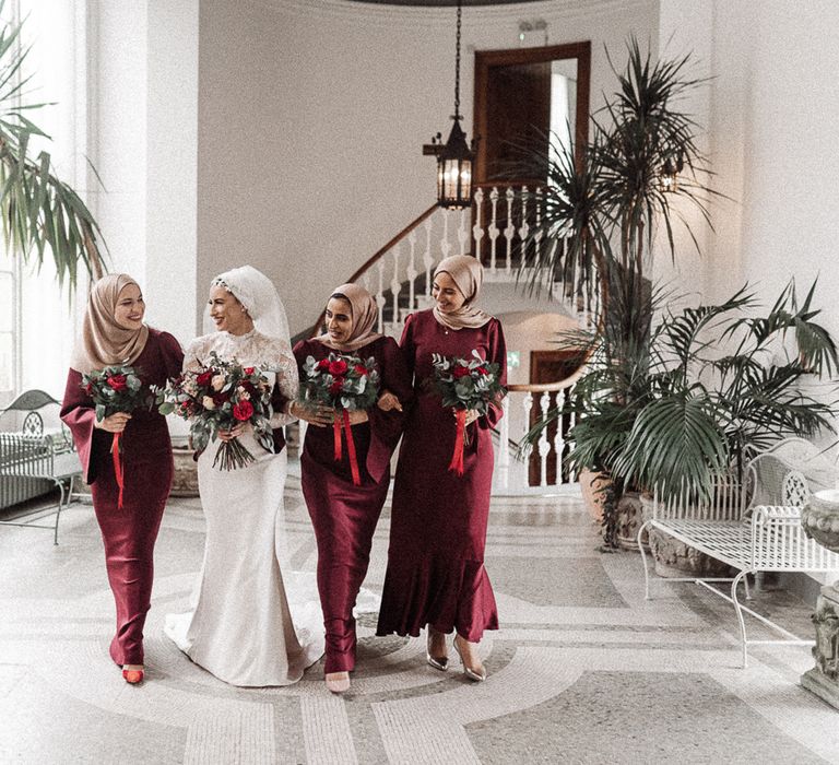 Bride and bridesmaids in maroon dresses at Hawkstone Hall & Gardens 