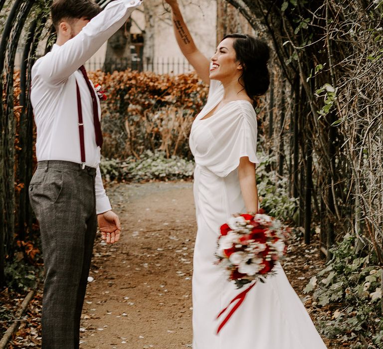 Bride and Groom dancing in gardens