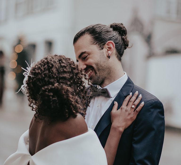 Bride & groom kiss on wedding day outdoors