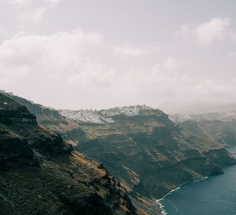 Mountains surround the beach in Santorini 