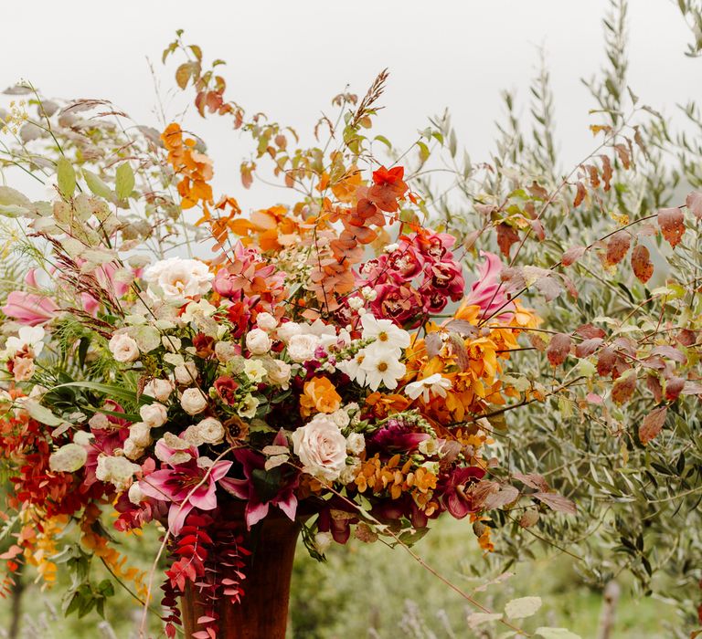 Huge floral display of pink, white and orange roses, orchids, eucalyptus leaves and lilies