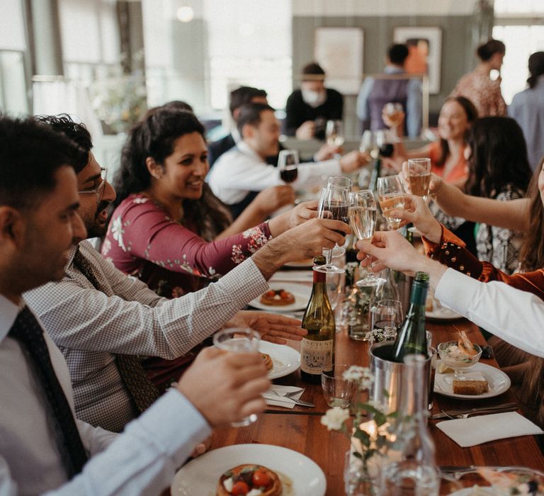 Guests toasting with champagne at a pub wedding reception